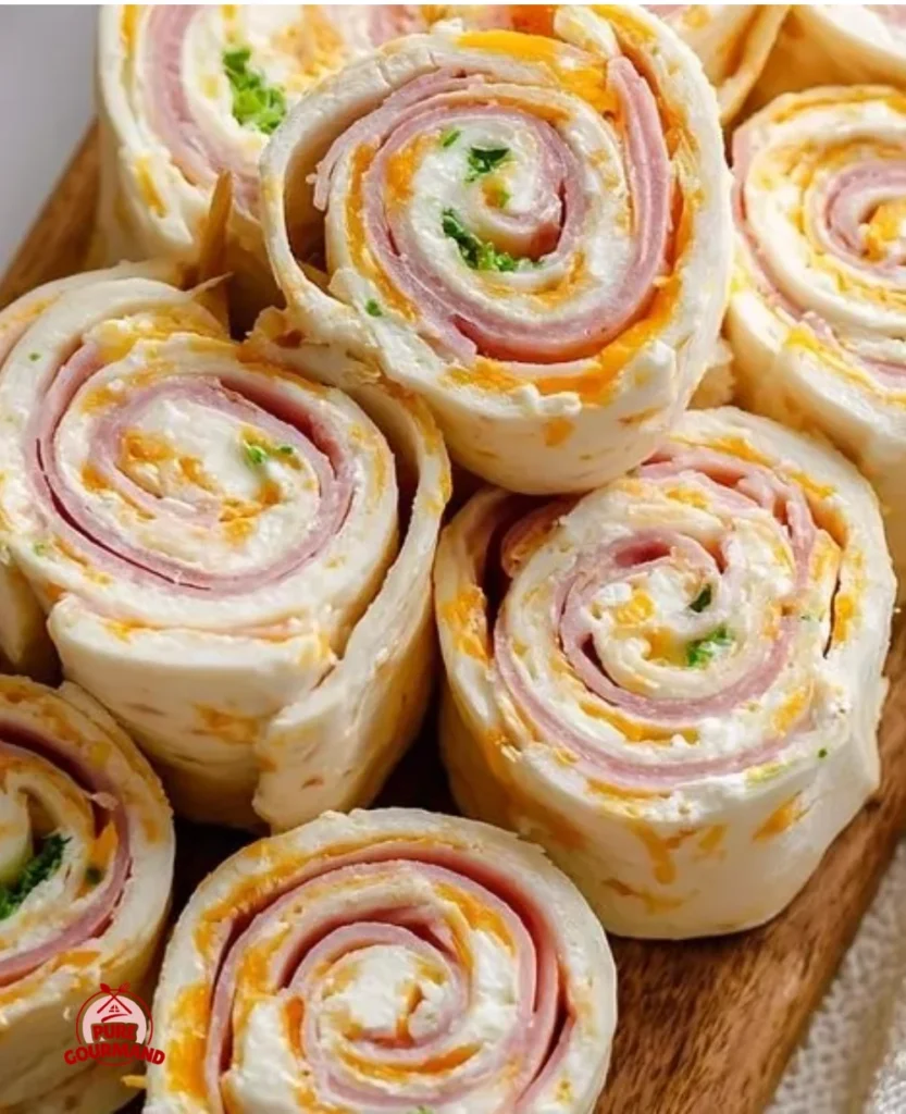 Delicious ham and cheese roll ups served on a platter.