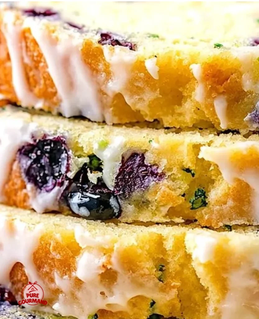 Sweet lemon blueberry zucchini bread fresh from the oven, garnished with blueberries.